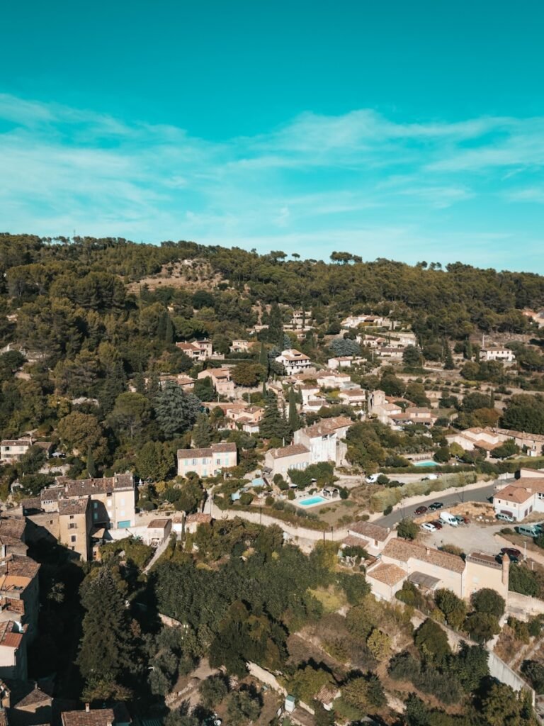 Aerial view of a village nestled among green hills.